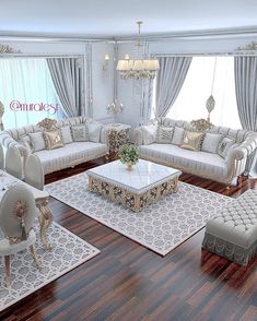 a living room filled with lots of white furniture