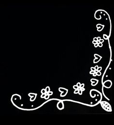 a black and white photo of a flowered design on the side of a wall