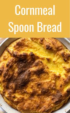 a close up of a pie on a plate with the words cornmeal spoon bread