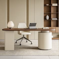 an office desk with a laptop on it in front of a bookcase and bookshelf