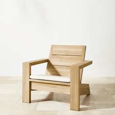 a wooden chair sitting on top of a tiled floor