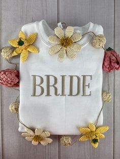 a white t - shirt with flowers and the word bride on it