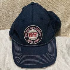 a new york city baseball cap on a bed