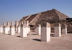 the pyramids are all lined up in front of each other on the dirt ground