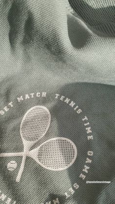 the back of a shirt with a tennis racket on it