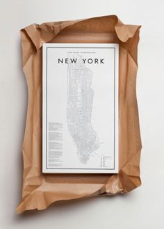 a new york city map in brown paper on a white background with the words'new york'written below it