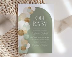 a baby shower is shown on top of a wicker basket with white and gold confetti