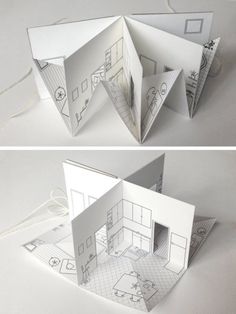 an open book with drawings on it and the inside cut out to look like a house