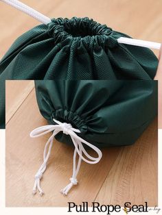 a drawstring bag sitting on top of a wooden floor next to a white string