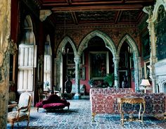 an ornately decorated living room with couches and chairs