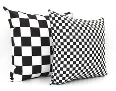 two black and white checkered pillows sitting next to each other on a white surface