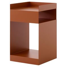 a brown cube shaped shelf sitting on top of a white wall