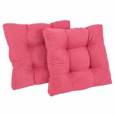 two red pillows sitting on top of each other