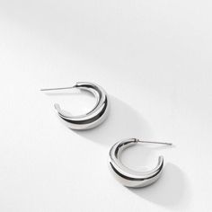 These crescent-moon-inspired earrings are just shiny enough to catch the light, but subtle enough to wear every day. Made from stainless steel. Modern Semi-circle Earrings For Everyday, Modern Crescent Hoop Earrings For Everyday, Minimalist Stainless Steel Hoop Earrings, Modern Semi-circle Earrings For Everyday Wear, Minimalist Metal Earrings With Shiny Finish, Everyday Stainless Steel Earrings With Polished Finish, Minimalist Crescent Hoop Earrings For Everyday, Minimalist Half Moon Earrings For Everyday, Elegant Moon-shaped Hoop Earrings For Gifts