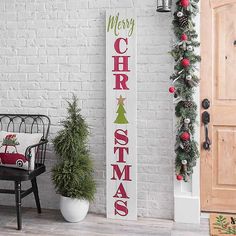 a porch decorated with christmas decorations and greenery