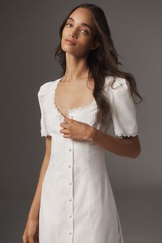 The Reformation Alida Dress features a scoop neckline, slightly puffed short sleeves, buttons down the front, and delicate lace trim detail. | Alida Midi Dress by Reformation in White, Women's, Size: 10, Cotton/Spandex at Anthropologie Cream Linen Dress, Sleeveless Denim Dress, The Reformation, Tuxedo Dress, Reformation Dress, Reformation Dresses, Knit Mini Dress, Lace Midi Dress, White Midi Dress