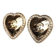 These Chanel small CC crystal heart earrings are in gold tone hardware, featuring gold heart shaped earrings with faux crystals along the edging with the signature CC logo in the center and post back closures.Origin: FranceCondition: New and never wornAccompanied by: Chanel jewelry boxMeasurements: .6" x 6" Luxury Gold Double Heart Earrings, Luxury Gold Heart Earrings, Gold Heart Earrings With Rhinestones For Valentine's Day, Gold Rhinestone Heart Earrings, Chanel Heart Earrings, Chanel Pink Earrings, Small Chanel Earrings, Chanel Gold Earrings, Gold Heart-shaped Earrings With Rhinestones