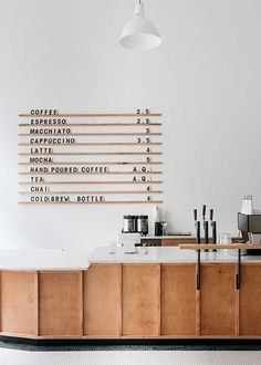 a coffee shop with wooden cabinets and white walls