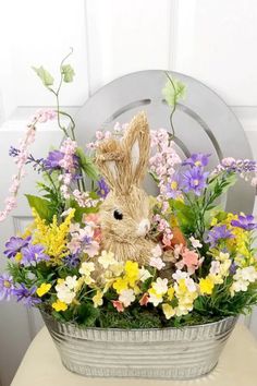 a basket filled with flowers and a stuffed animal