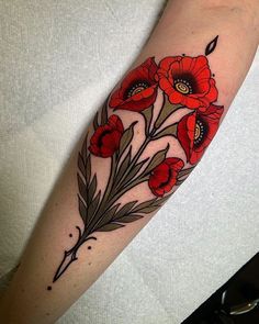 a woman's arm with red flowers on it