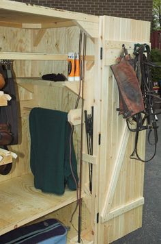 the inside of a wooden storage shed with many items in it