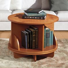 a coffee table with books on it and a couch in the background