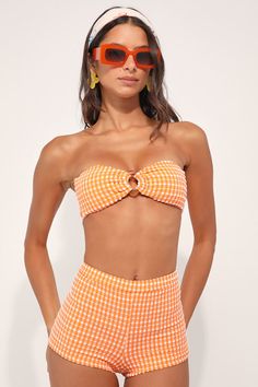 Beach days aren't complete without the Dippin' Daisy's Farrah Orange Gingham Swim Shorts! Crinkly stretch-knit, with a white gingham pattern, creates an elasticized high-waist and skimpy bottom coverage, perfect for pairing with your bikini top. PLEASE NOTE: Swimwear returned without the hygienic liner is non-refundable Fit: This garment fits true to size. Length: Above mid-thigh. Size medium Waist: Fitted - stretchy fabric allows custom fit. Hip: Fitted - stretchy fabric allows room for hips. F Gingham Outfit, Orange Gingham, Vintage Swimwear, Gingham Pattern, Beach Shorts, Beach Days, Bottom Clothes, 70s Fashion, Stretchy Fabric