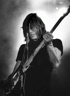 black and white photograph of a man playing an electric guitar