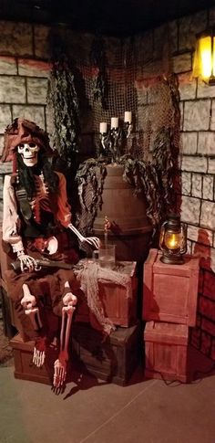 a fake skeleton sitting on top of a chair next to a fire place in a room