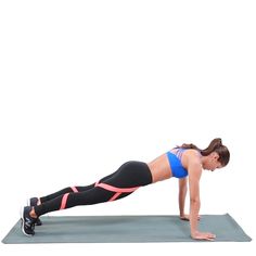 a woman is doing push ups on a yoga mat