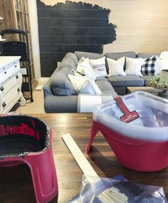 a living room filled with furniture and lots of pillows on top of a wooden table