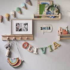 there are some shelves with pictures on them and letters that spell out the word smile