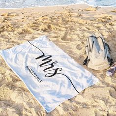 a towel and backpack sitting on the beach