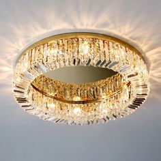 a round mirror mounted to the side of a ceiling fixture with lights on each end