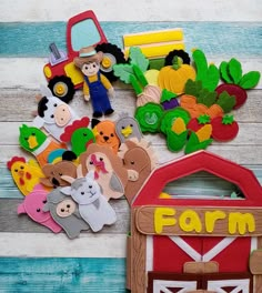 farm animals and farmer's signs are on the table next to a toy barn