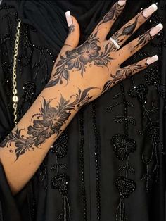 a woman with tattoos on her arm and hand