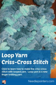 a pile of yarn sitting on top of a wooden floor next to a blue sign that says loop yarn criss - cross stitch