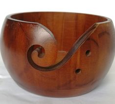 a wooden bowl with an intricate design on the bottom and sides, made out of wood