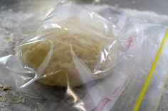 a doughnut wrapped in plastic sitting on top of a counter