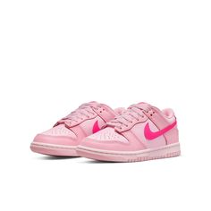 The Nike Dunk Low GS 'Triple Pink' is the ultimate representation of eye-catching style. The shoe offers full leather construction, which is brought to life with three distinct peppery shades of pink. The lightest shade provides the foundation for this cheerful design, with a slightly darker overlaying hue adding depth and detail. To make a bold statement, Nike branding swoops in with a vibrant pink Swoosh across both sides of the low-profile silhouette, complemented by further branding on sole, heel, tongue and inner sole. Grade School (GS) sizing adds further options for fashion-forward kids. Whether you're looking to complete an already aesthetically pleasing ensemble or just want something to brighten up your little one's day, the Nike Dunk Low GS 'Triple Pink' is sure to do the job. Nike Dunk Low Triple Pink, Pink Jordans, Preppy Shoes, Pretty Shoes Sneakers, Nike Models, Different Shades Of Pink, Jordan 12 Retro, Cute Nike Shoes, Cute Nikes