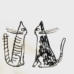 two black and white drawings of cats sitting next to each other on a sheet of paper