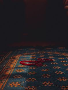 a red object laying on top of a blue rug