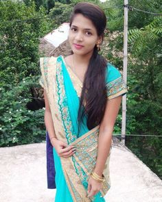 a woman in a blue sari posing for the camera