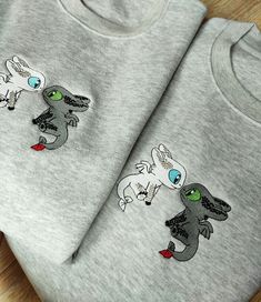 two gray t - shirts with cartoon images on them