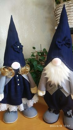 two gnomes sitting on top of a wooden table