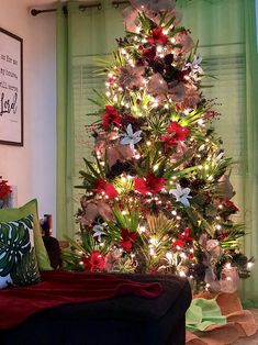 a christmas tree decorated with red, white and green decorations