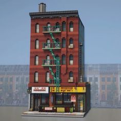 a tall red brick building sitting on top of a parking lot next to a green fire hydrant