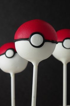 three lollipops with white and red frosting on them in the shape of pokemon pikachu