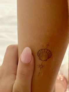 a woman's foot with a small tattoo on the side of her left leg