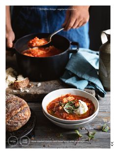 a bowl of soup and bread on a table